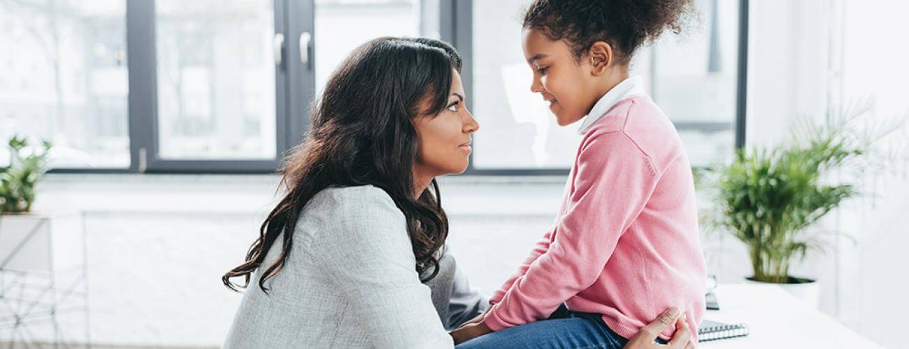 mother holding their child talking to them