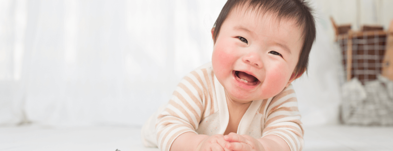 baby laughing at camera