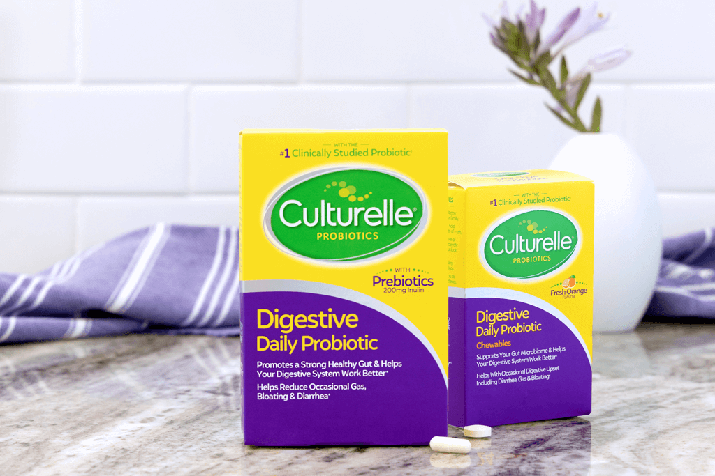 Culturelle Daily Probiotic packaging on table in front of a plant in a vase